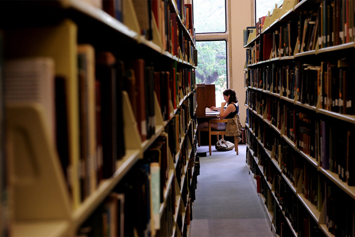 Corridor Of Library Books With Girl In Background