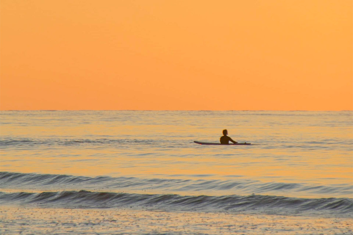 Lone Surfer At Sunset