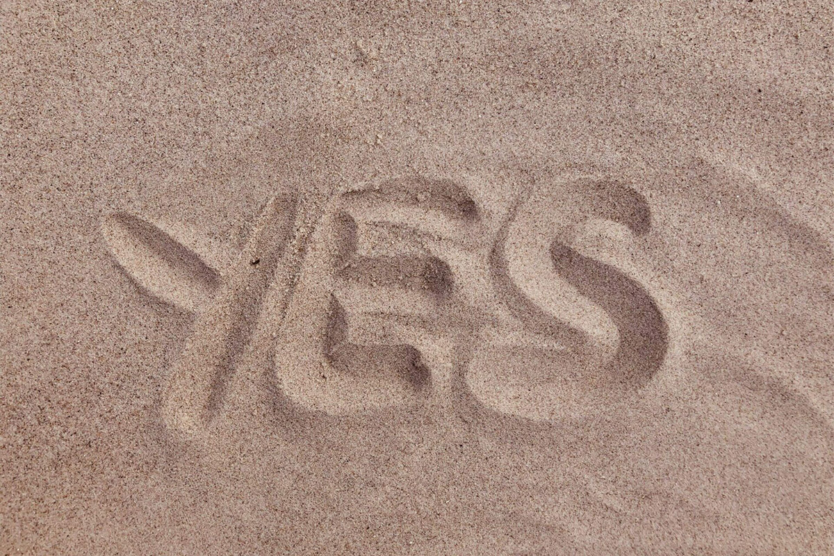 The Word Yes Traced In The Sand