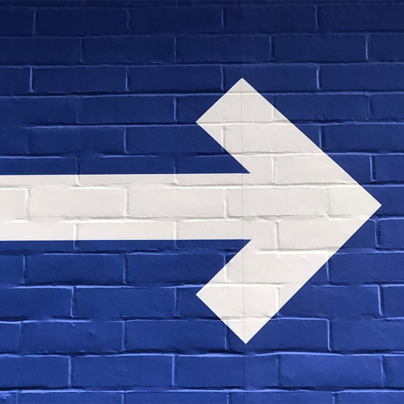Arrow On Blue Bricks