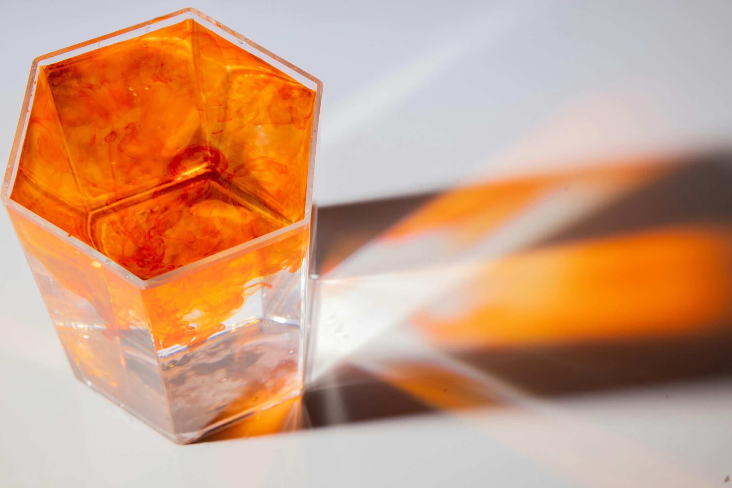 Clear liquid with orange dye in a square glass